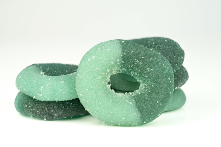 Green and black sugar-coated gummy rings.