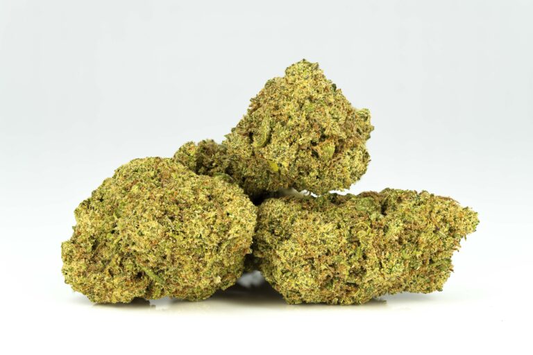 Close-up of cannabis buds on white background.