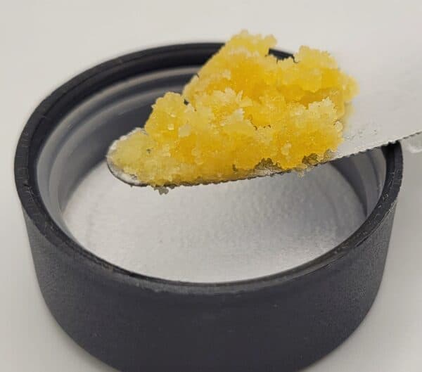 gluestix wax on a knife over a lid