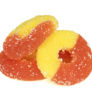 Sugar-coated peach rings candy on white background.