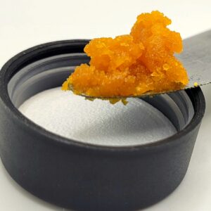 sour bremix wax on a knife over a lid